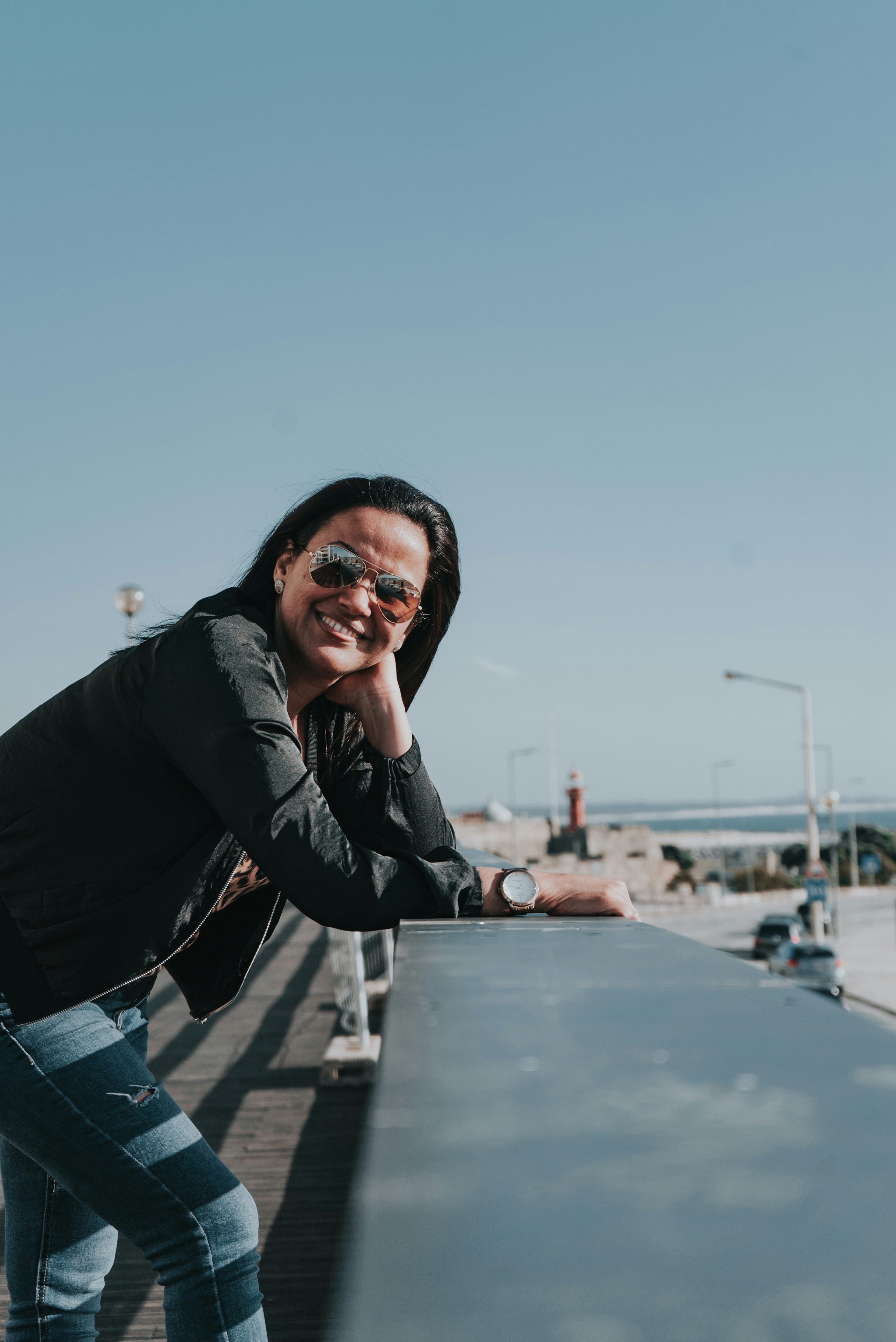 woman in black leather jacket and blue denim jeans